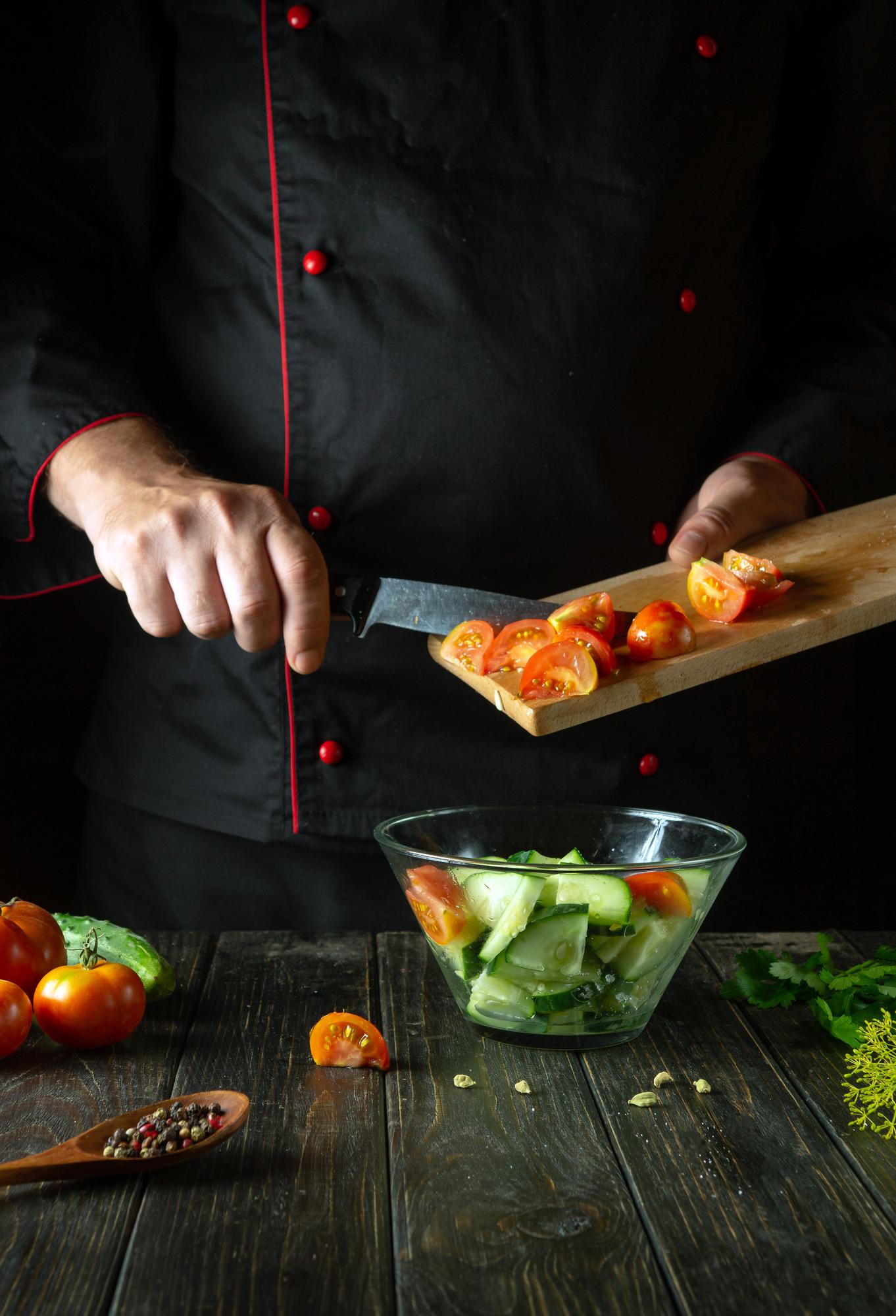 Chef arranging garnish in kitchen