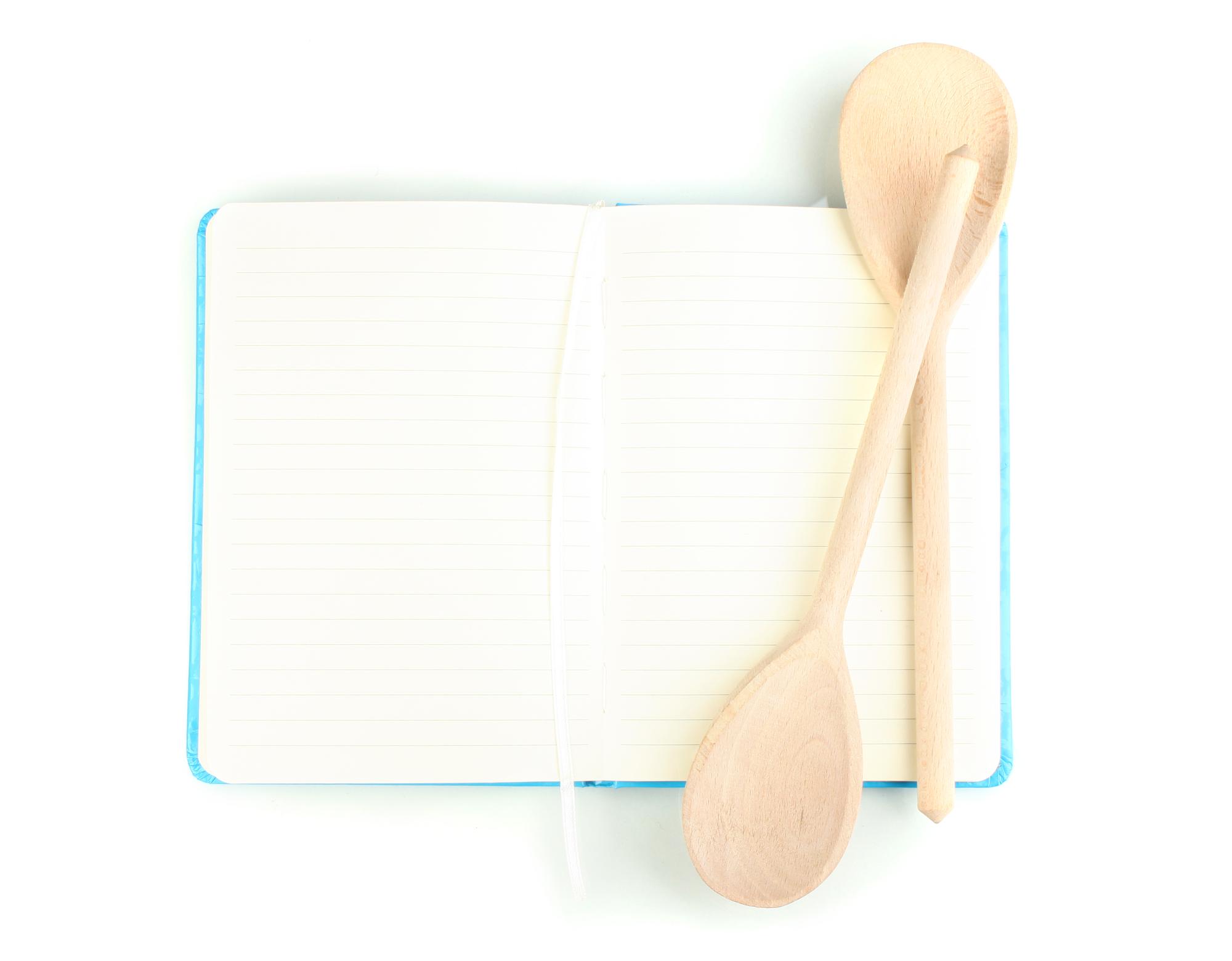 Flat lay of meal planning notebook and utensils